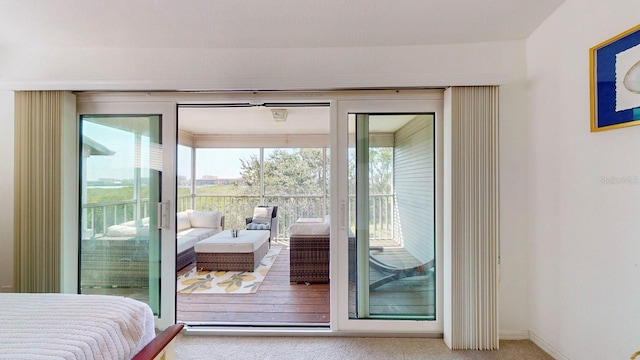 carpeted bedroom featuring access to outside