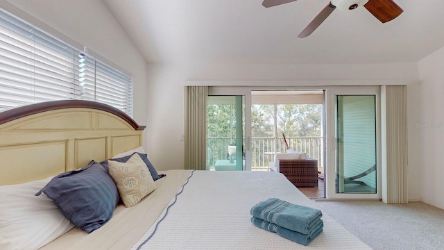 carpeted bedroom featuring ceiling fan, vaulted ceiling, and access to exterior