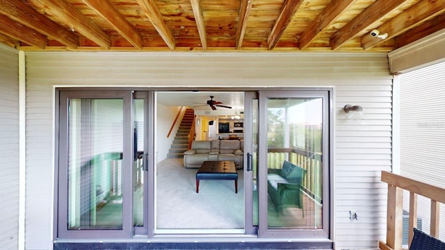 view of exterior entry with ceiling fan