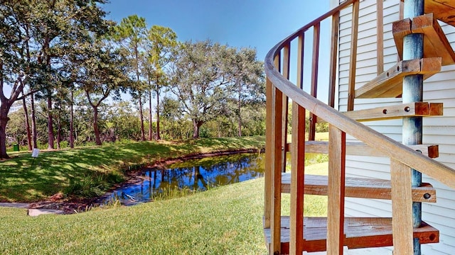 view of yard with a deck with water view