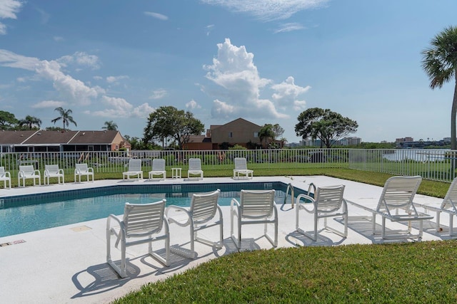 view of swimming pool featuring a lawn and a patio