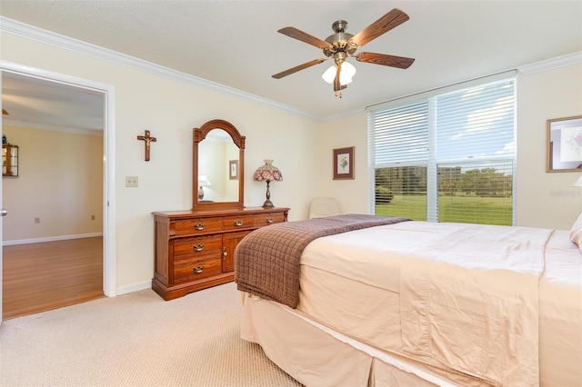 bedroom featuring ceiling fan, light hardwood / wood-style flooring, and ornamental molding