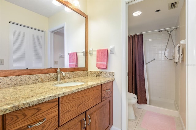 bathroom with curtained shower, tile patterned flooring, vanity, and toilet