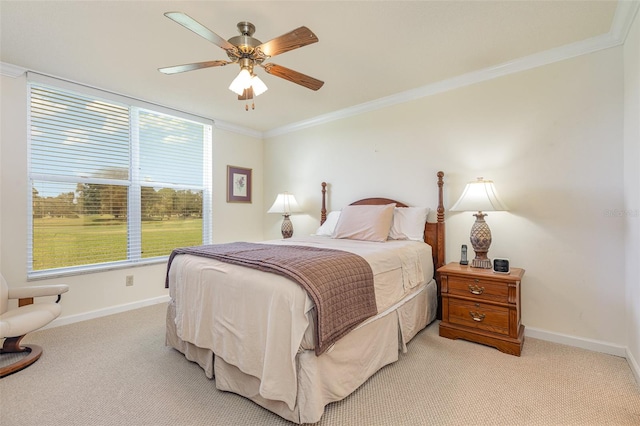 carpeted bedroom featuring ornamental molding and ceiling fan