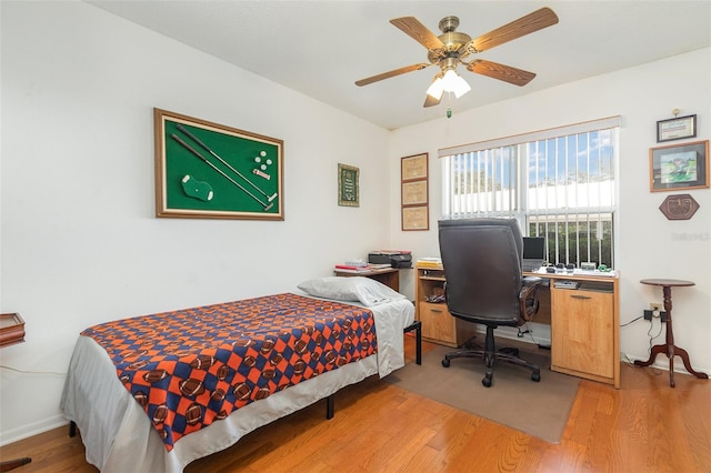 bedroom with ceiling fan and hardwood / wood-style flooring