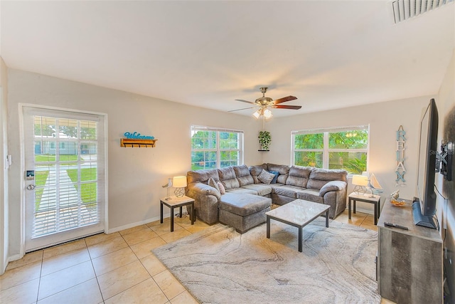 living room with ceiling fan and light tile patterned flooring