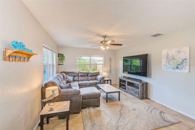 tiled living room with ceiling fan