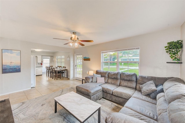 tiled living room with ceiling fan