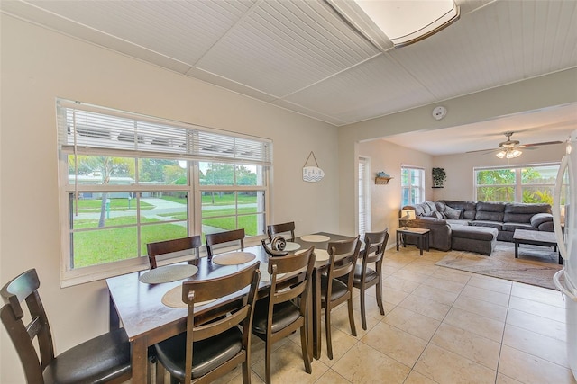 dining space with ceiling fan and light tile patterned flooring