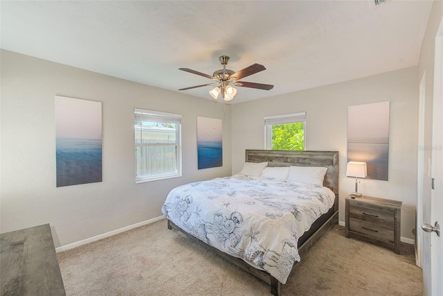 bedroom with ceiling fan and light colored carpet