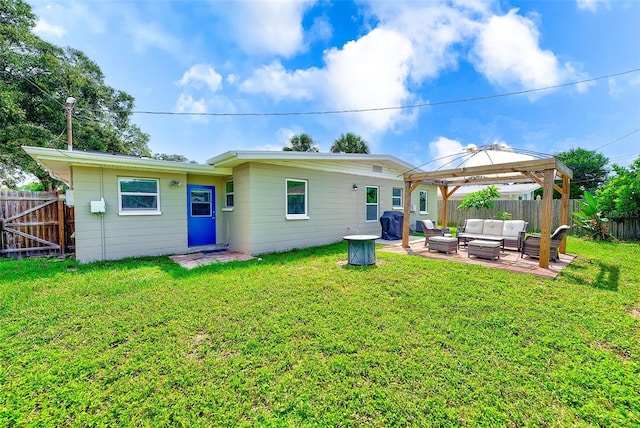 back of property with a gazebo, a yard, an outdoor living space, and a patio area