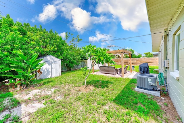 view of yard featuring a storage unit, central AC, and a patio area