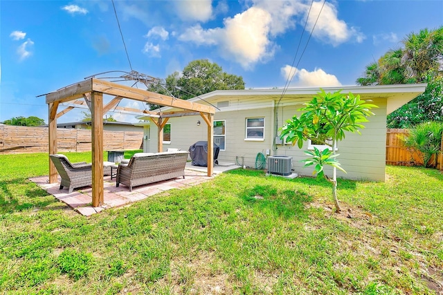 back of property with a lawn, a patio, an outdoor living space, and central AC