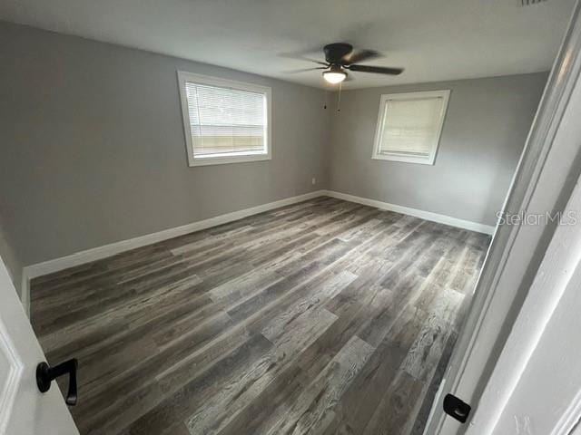 spare room featuring ceiling fan and dark hardwood / wood-style flooring