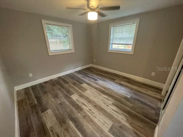 spare room with ceiling fan and dark hardwood / wood-style flooring