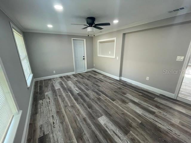 unfurnished bedroom featuring ornamental molding, dark wood-type flooring, and ceiling fan