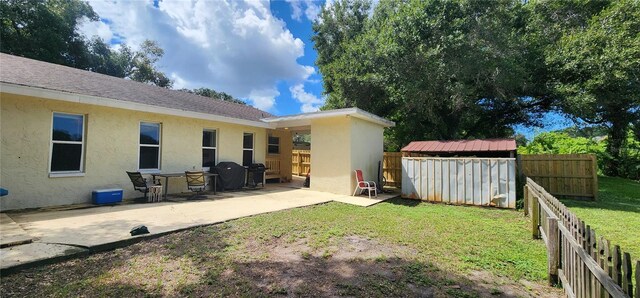 view of yard featuring a patio and a shed