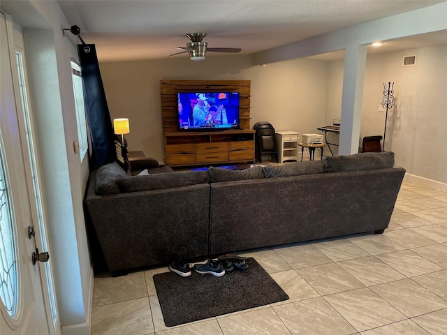 living room featuring ceiling fan and light tile patterned flooring