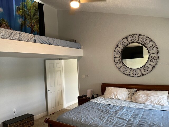 bedroom with carpet floors and a textured ceiling