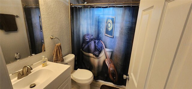 bathroom with tile patterned flooring, vanity, toilet, and a shower with shower curtain