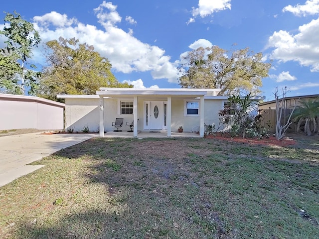 view of front facade featuring a front yard, fence, and stucco siding