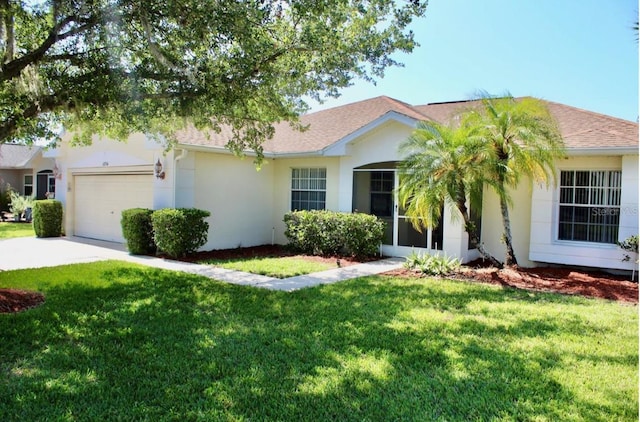 ranch-style house featuring a front lawn and a garage