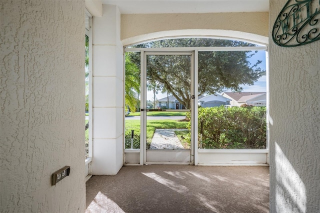 doorway featuring carpet flooring