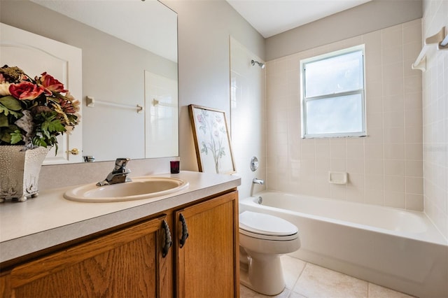 full bathroom with vanity, tile patterned floors, tiled shower / bath, and toilet