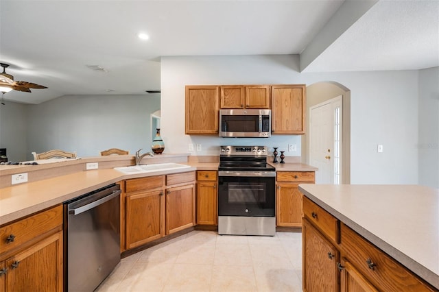 kitchen with stainless steel appliances, ceiling fan, light tile patterned floors, and sink