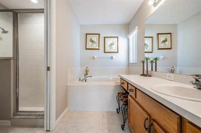 bathroom featuring vanity, tile patterned floors, and separate shower and tub