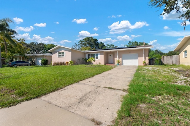 single story home with a front yard and a garage