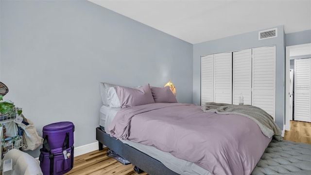 bedroom featuring light hardwood / wood-style floors and a closet