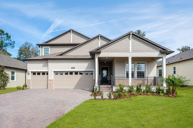 craftsman house featuring a porch, a garage, and a front yard