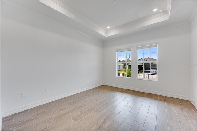 spare room featuring crown molding and a tray ceiling