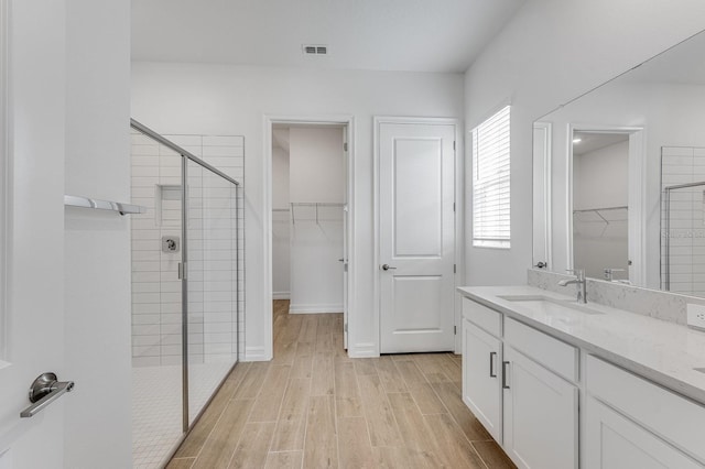 bathroom with vanity and walk in shower