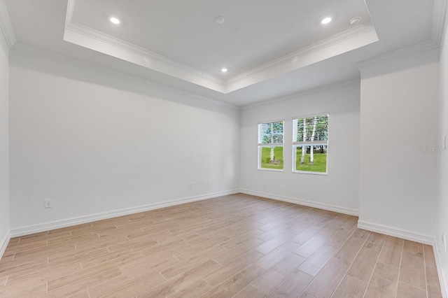 unfurnished room featuring a tray ceiling and ornamental molding