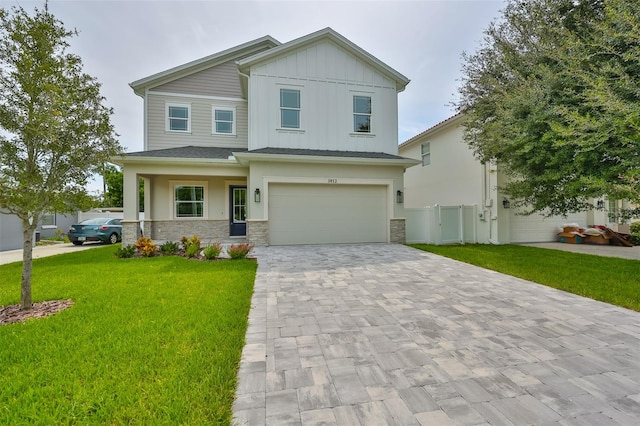 view of front of house with a front yard and a garage