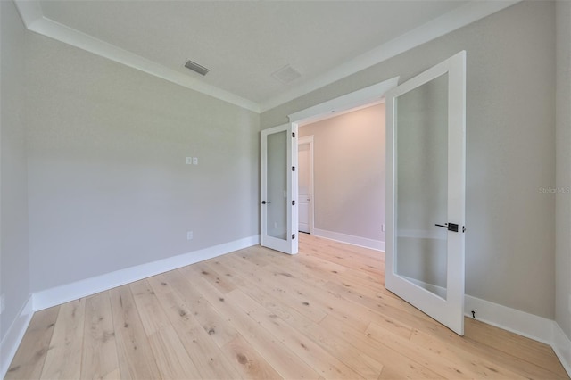 unfurnished room with light hardwood / wood-style floors and ornamental molding