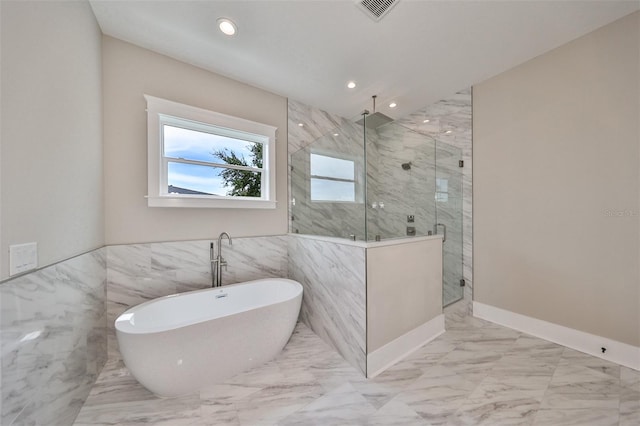 bathroom with tile walls and plus walk in shower