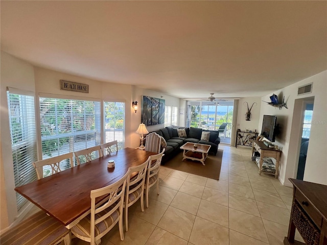 tiled dining space featuring ceiling fan