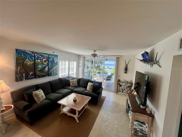 living room with ceiling fan and light tile patterned floors