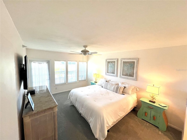 bedroom featuring dark colored carpet and ceiling fan