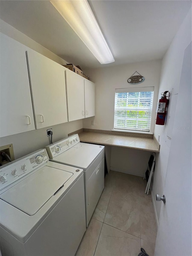 laundry area with cabinets and separate washer and dryer