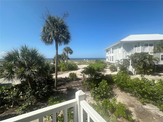 view of yard with a balcony and a water view