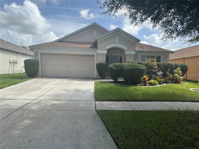 single story home featuring a garage and a front lawn