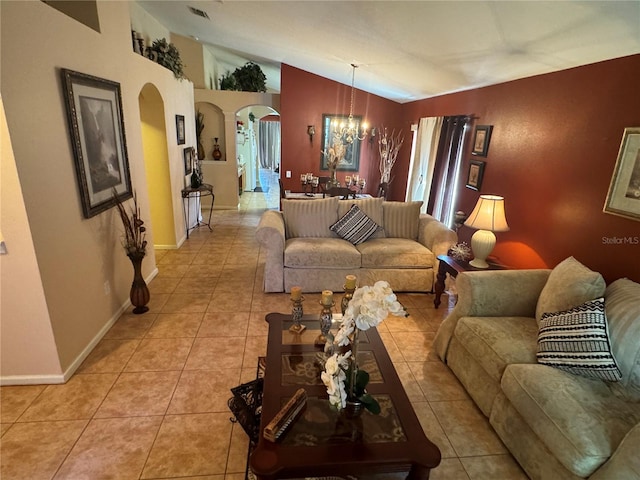 tiled living room featuring vaulted ceiling and a notable chandelier