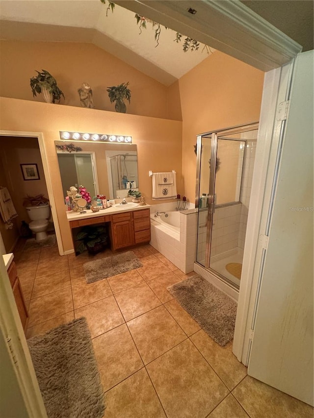 full bathroom with vanity, lofted ceiling, separate shower and tub, toilet, and tile patterned floors