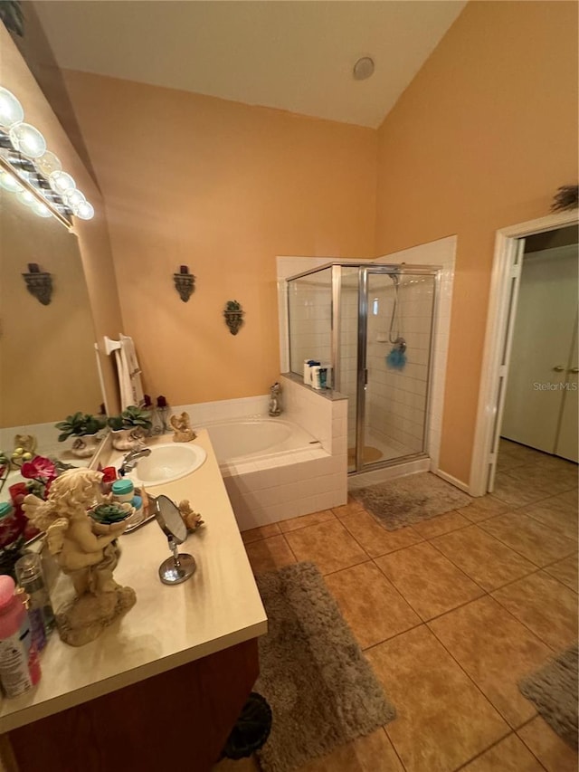 bathroom featuring vanity, shower with separate bathtub, and tile patterned flooring