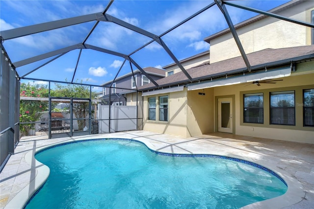 view of pool with a lanai, ceiling fan, and a patio area