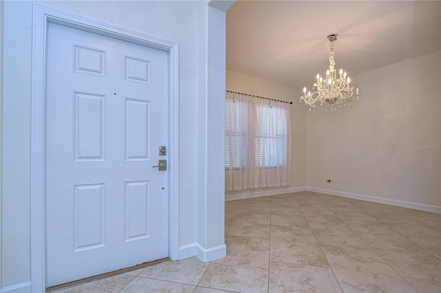 entryway featuring a notable chandelier and light tile patterned floors